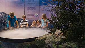 Children gathered around cloud exhibit