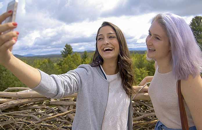 Two young women taking selfie in Wild Walk nest