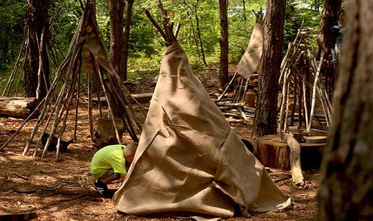 Child behing Wild Pines tent