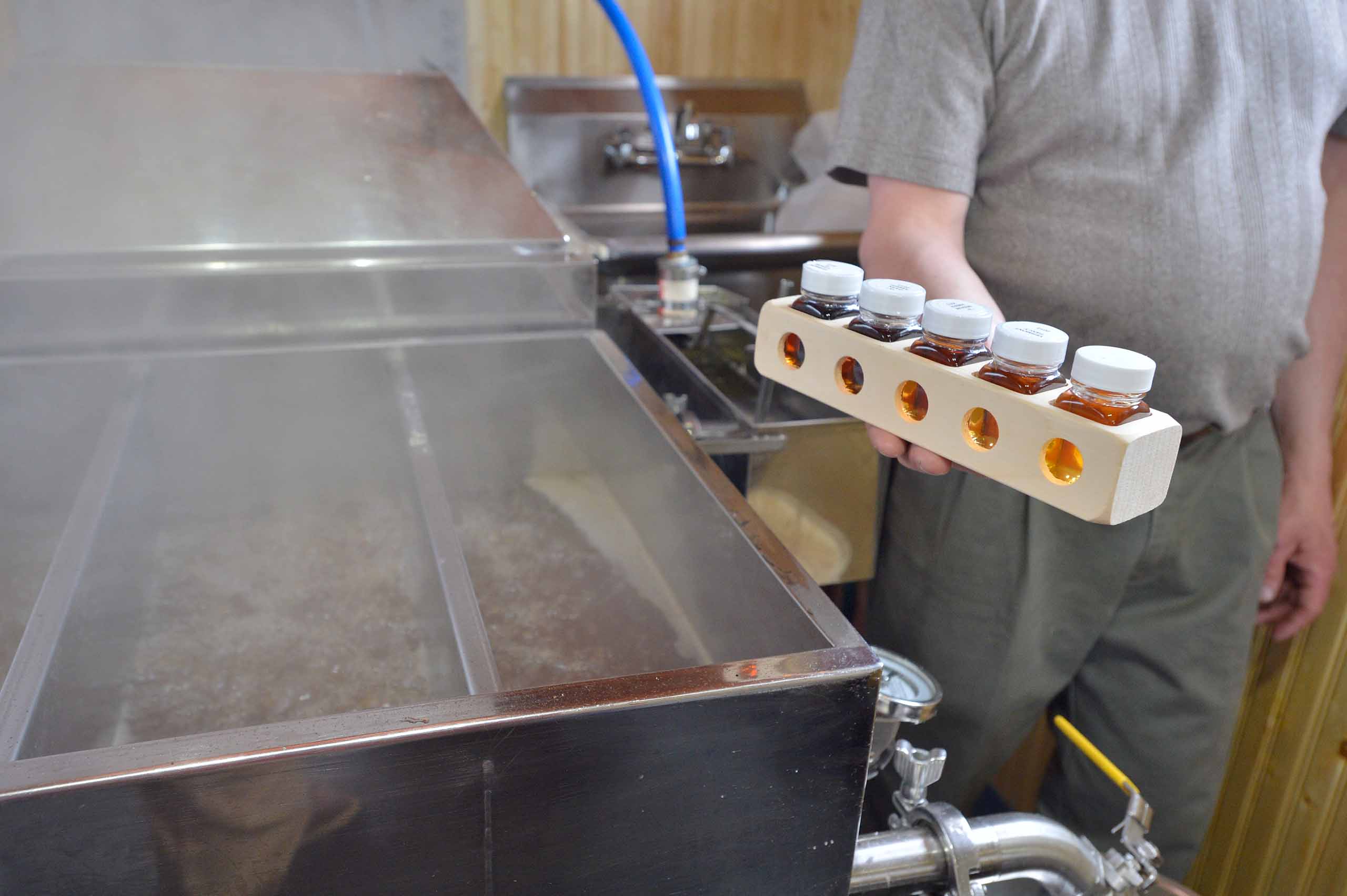 Maple syrup worker displaying maple grading kit