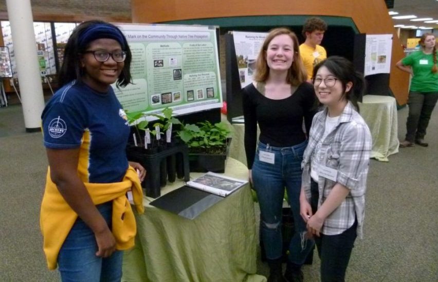 Group of students in front of their display