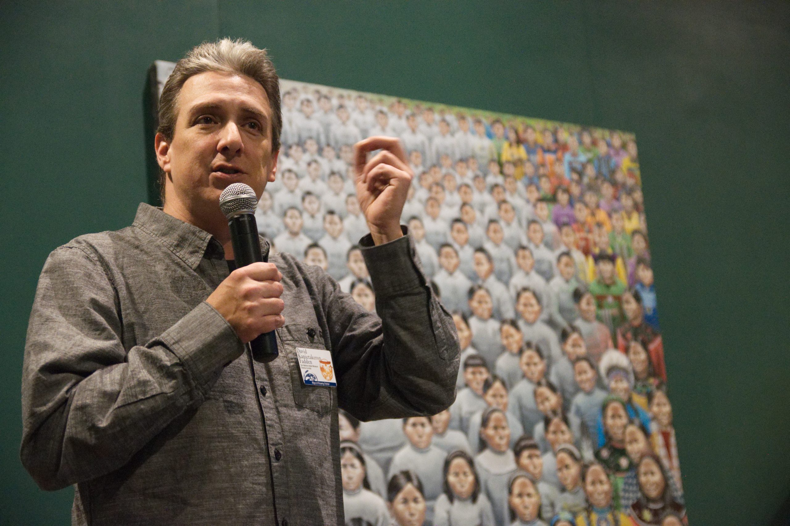 Artist with microphone explaining his painting