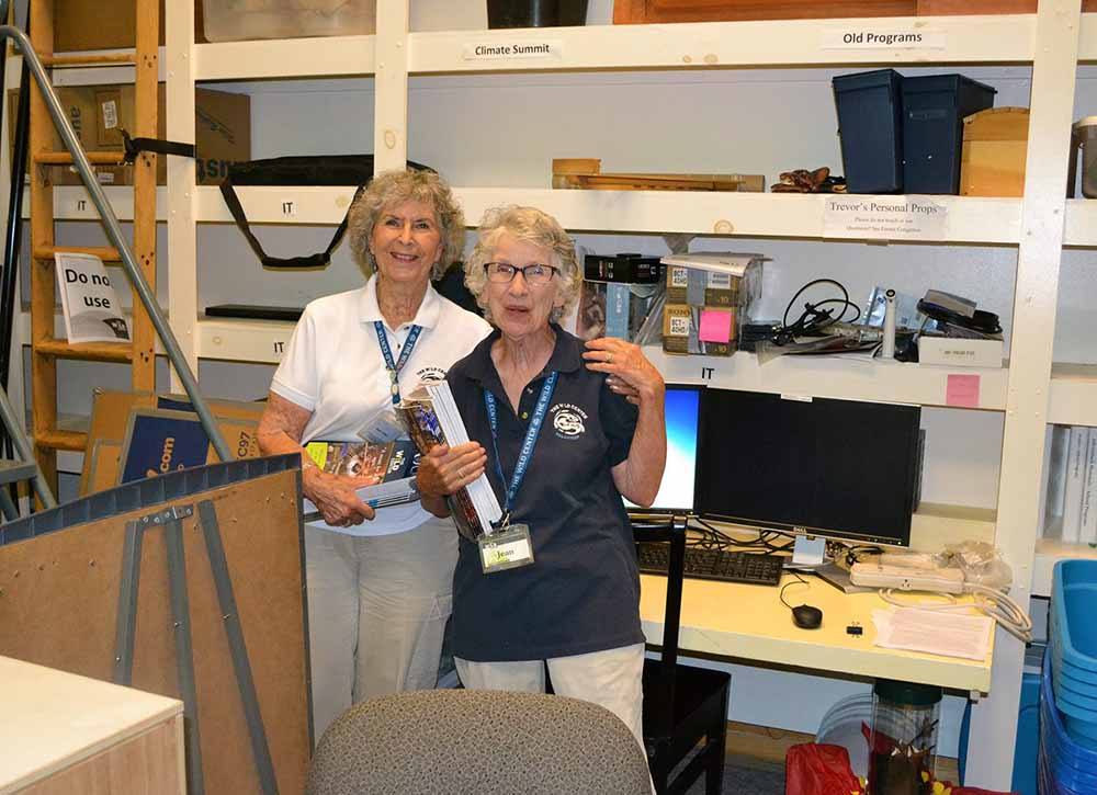 Two women in Wild Center storage room