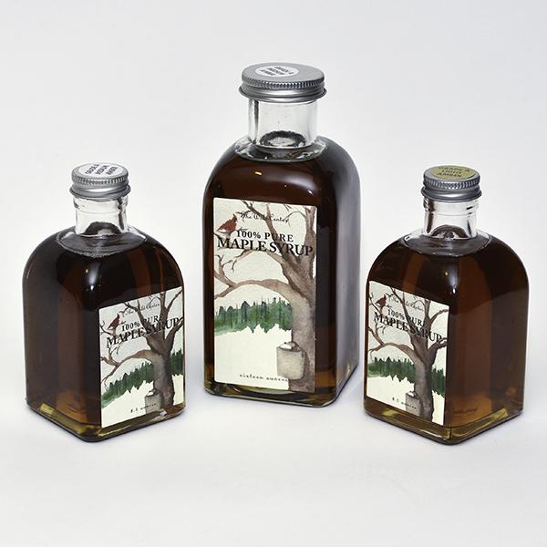 Three bottles of maple syrup in different sizes