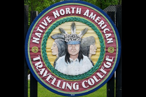 Native North American Travelling College logo in woodcut sign