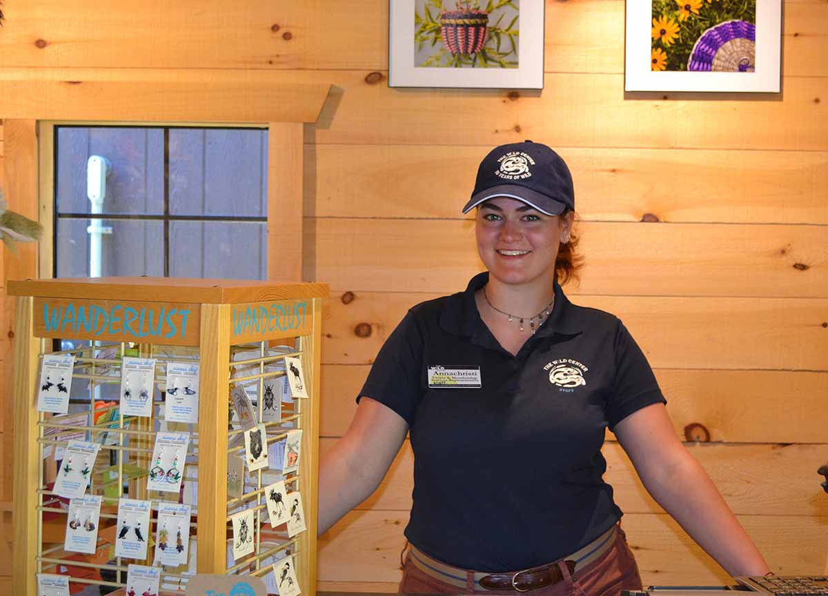 Teenage volunteer at gift shop counter