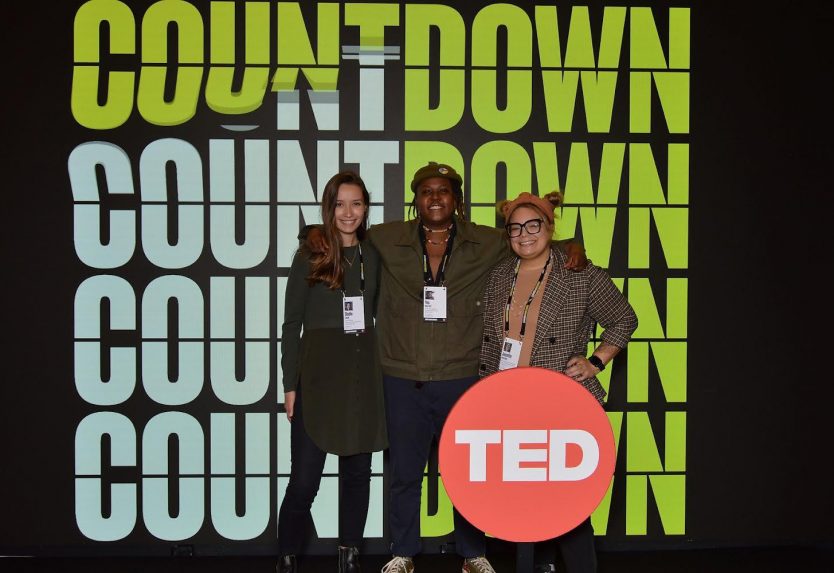 Attendees in front of TED signage