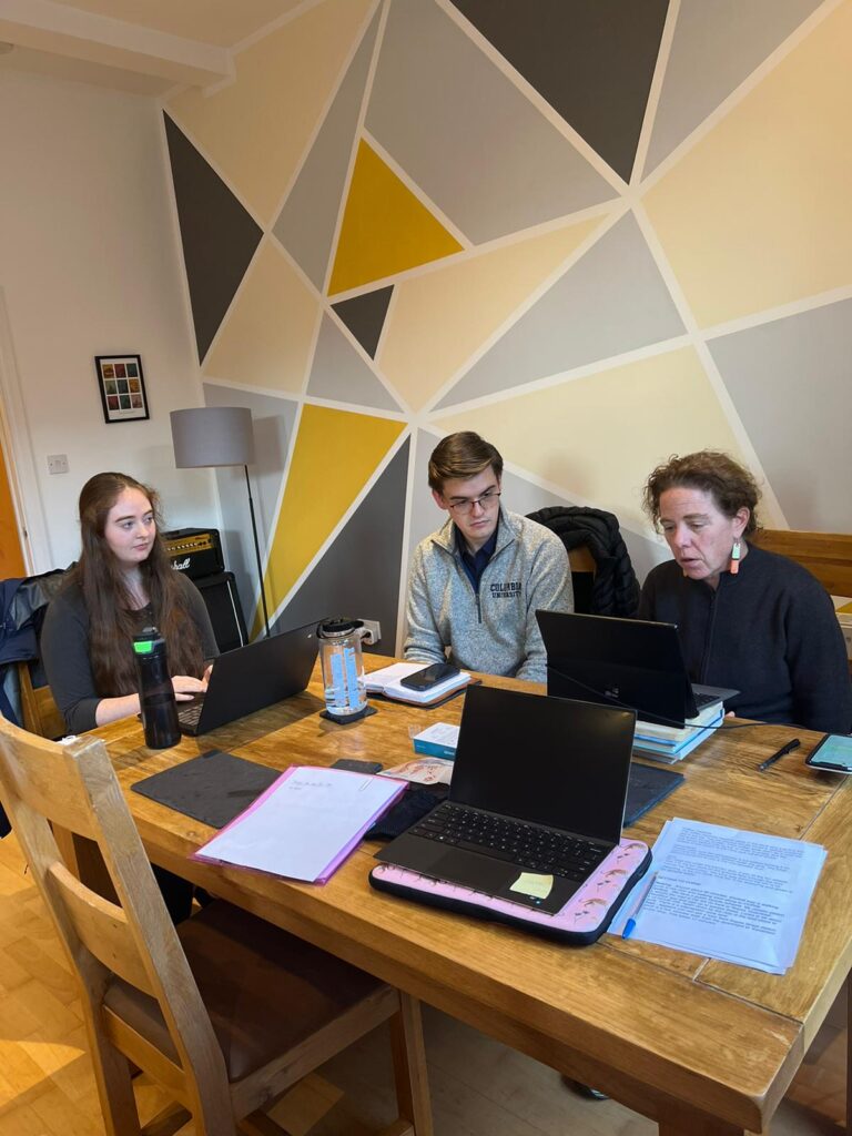 Three people at work sitting at table